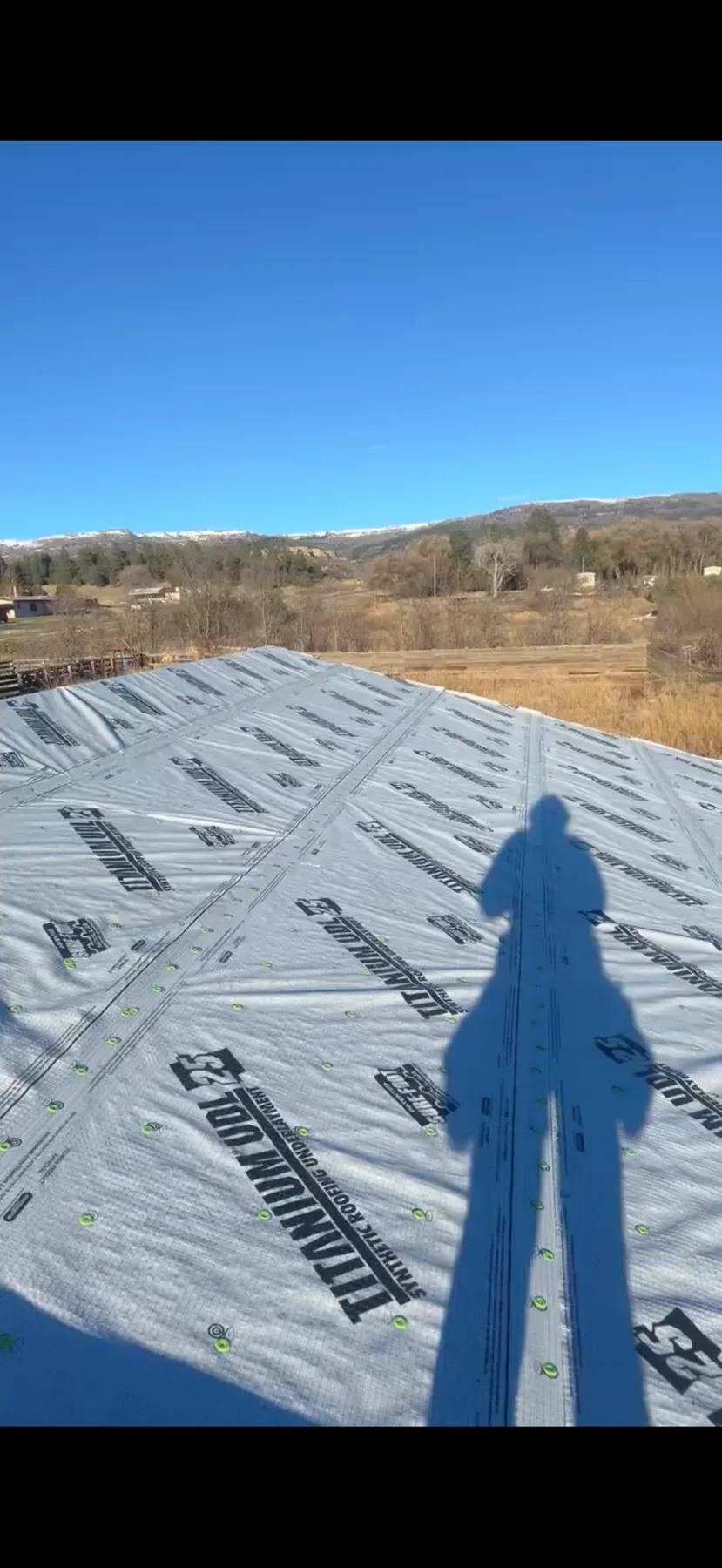 Roof covered with synthetic underlayment during installation