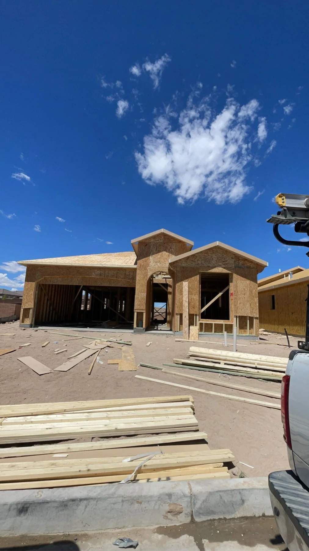 New residential home under construction with framing, roof sheathing, and exterior wall sheathing installed